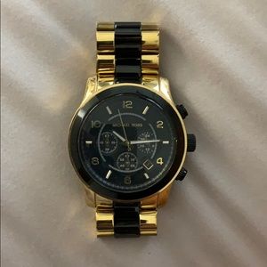 Gold and black Michael Kors watch